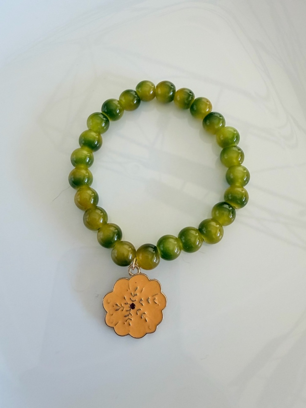 Green Beaded Stretch Bracelet with Gold Flower Pendant